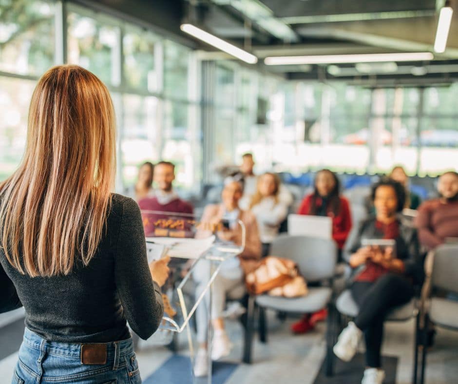 Stager giving a home staging presentation for a group of realtors